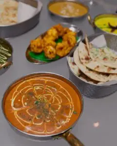 Herb-topped rice dish and curries served at Meghna Grill, Indian restaurant in St John's Wood NW8